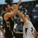 Dexter senior Michael Mioduszewski is fouled by Pioneer junior Ethan Spencer during the second half of a district match up at Pioneer on Wednesday. Melanie Maxwell I AnnArbor.com